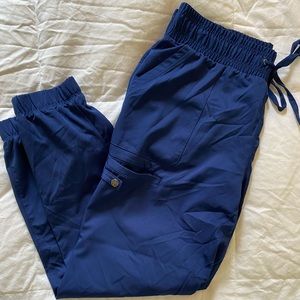 Navy blue healing hands jogger style scrub bottoms. Size L
